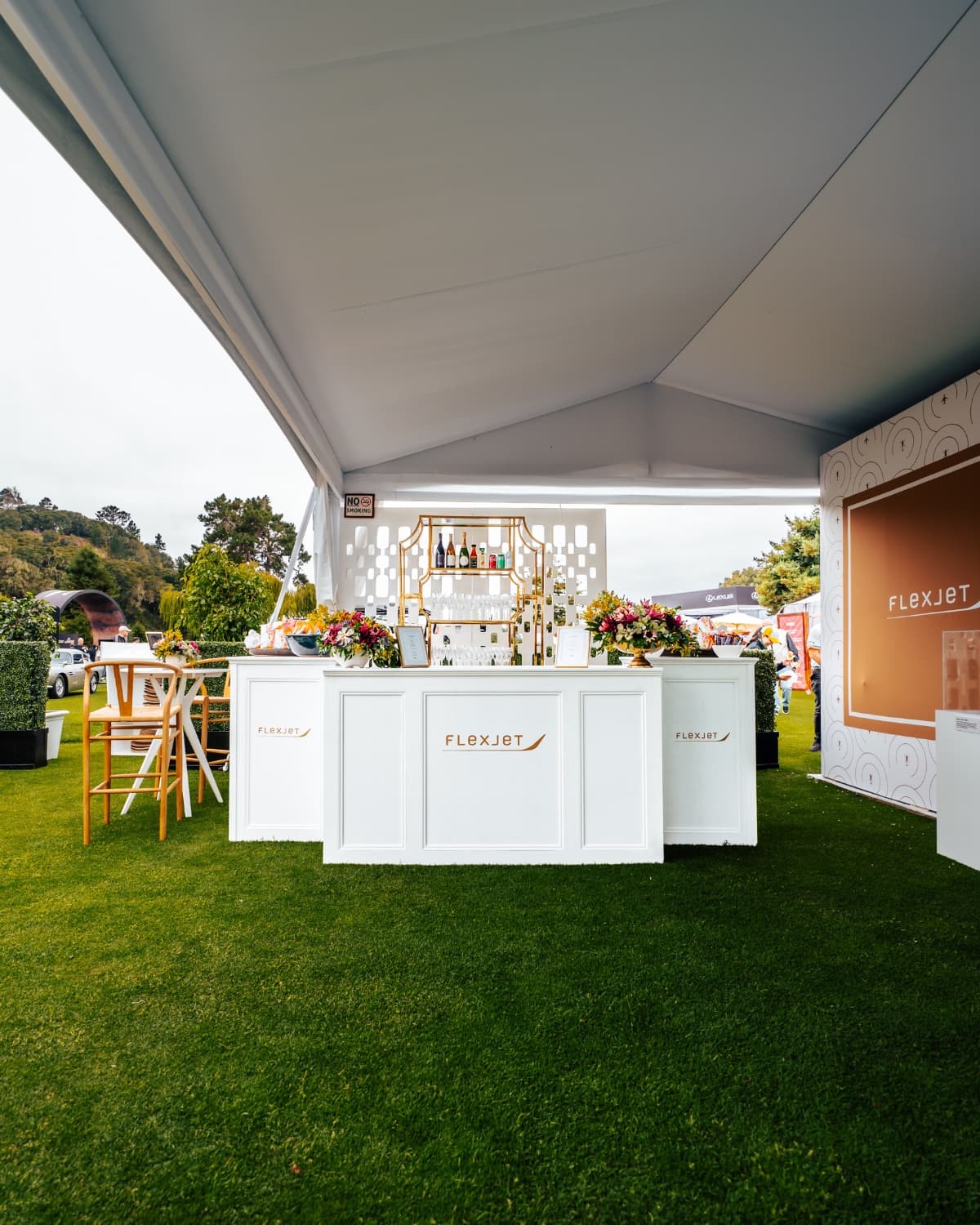 Premium event hospitality activation — branded bar setup at a luxury concours
