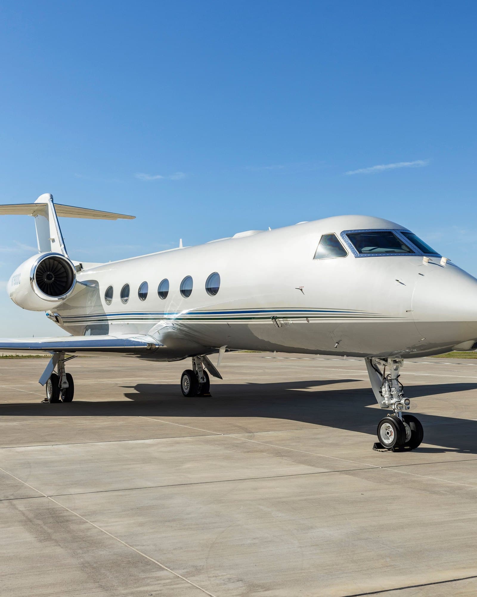 Private jet on tarmac with airstairs down and red carpet