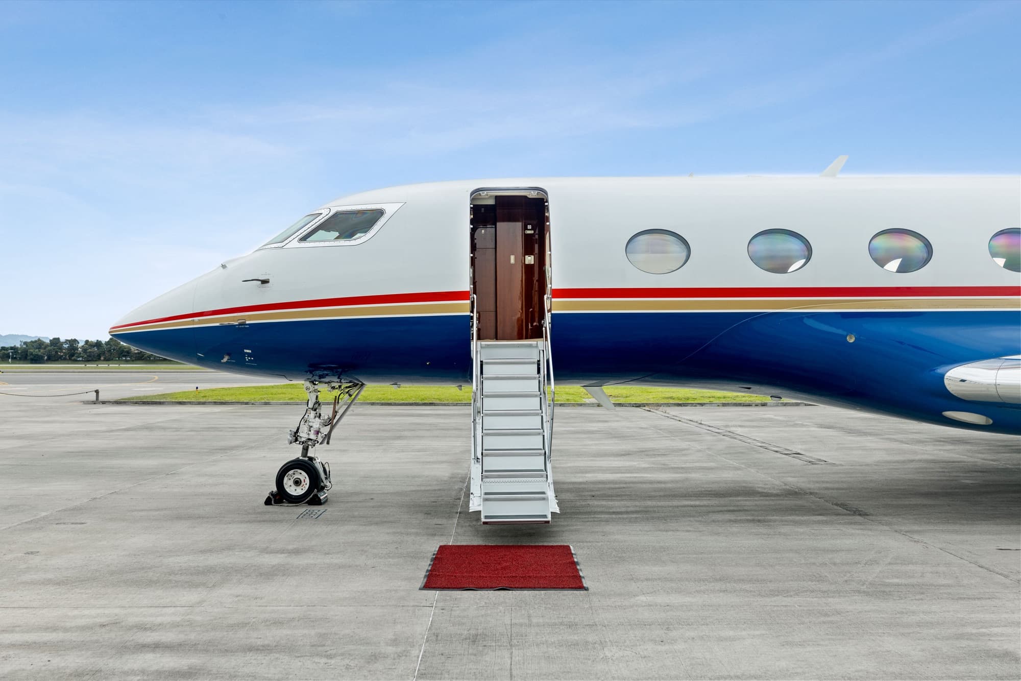 Gulfstream G650ER with airstairs down and red carpet on the ramp