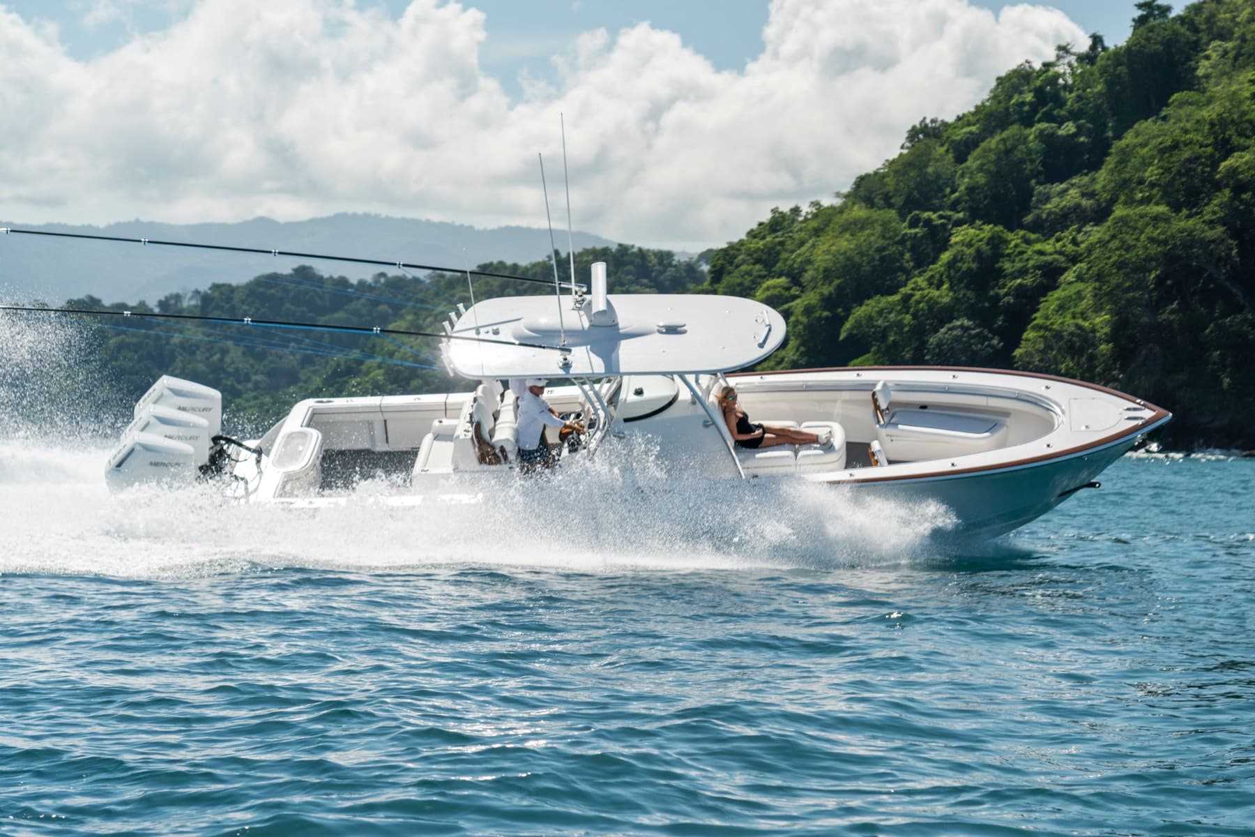 Center console boat running fast along lush Costa Rican coastline