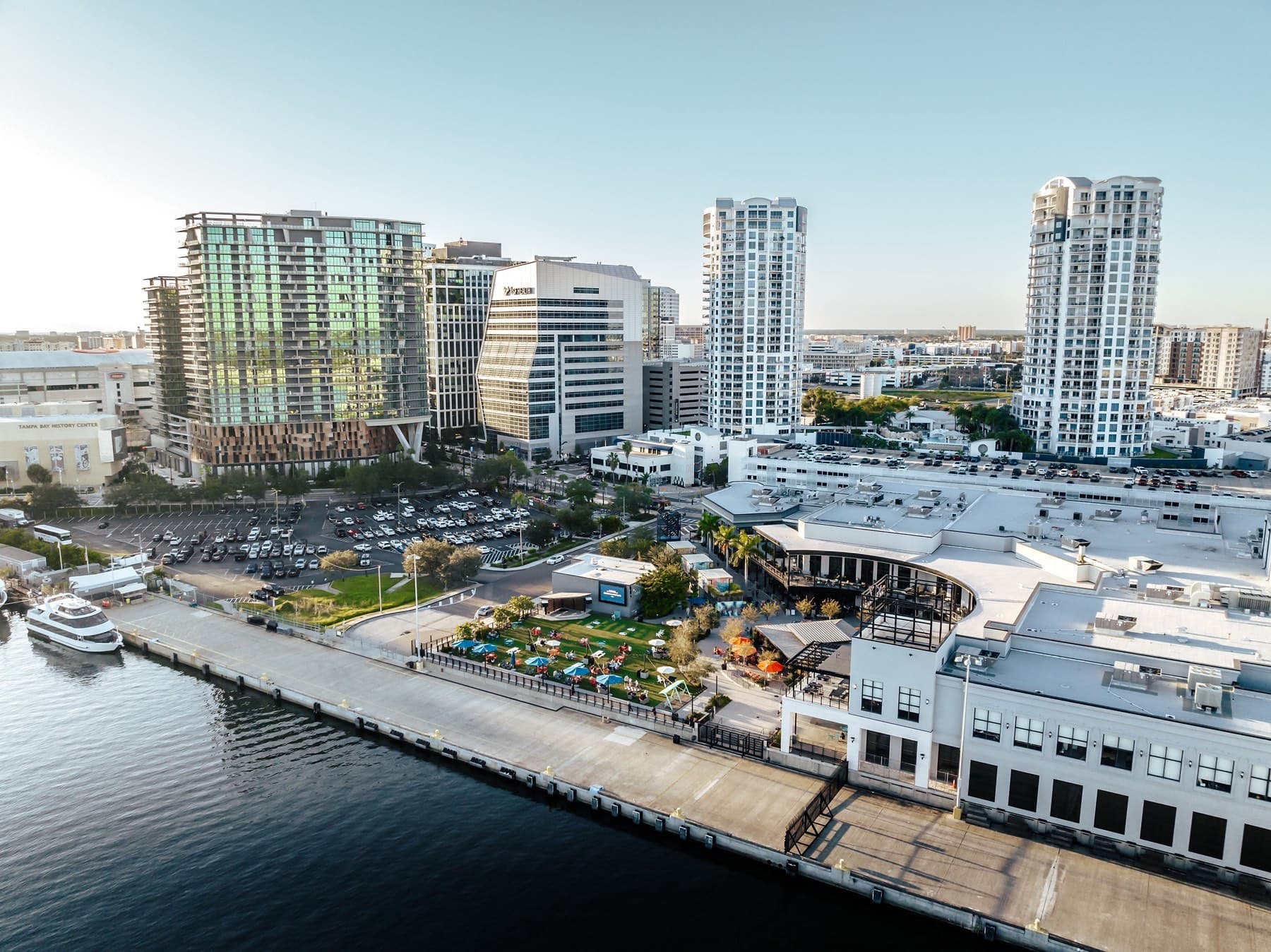 Aerial of Sparkman Wharf lawn and marina against Tampa skyline
